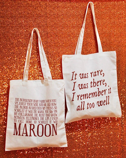 Two tote bags with text on a textured red background