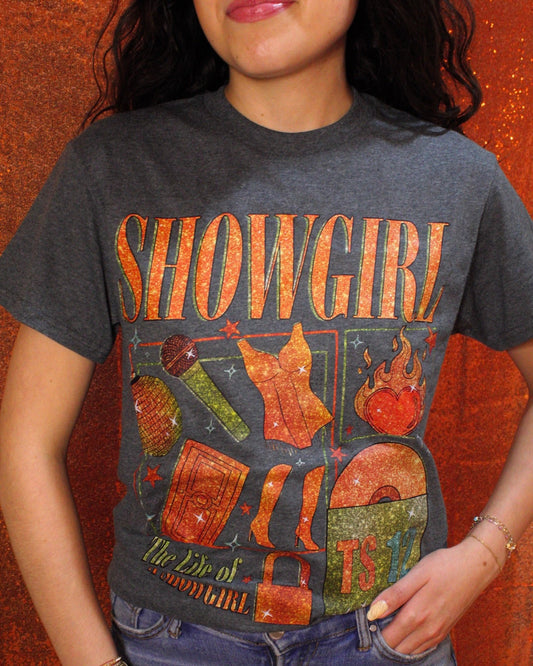 Person wearing a 'Showgirl' t-shirt with graphics on an orange background